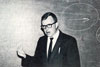 Thumbnail of Dr. William Bott in front of a chalk board