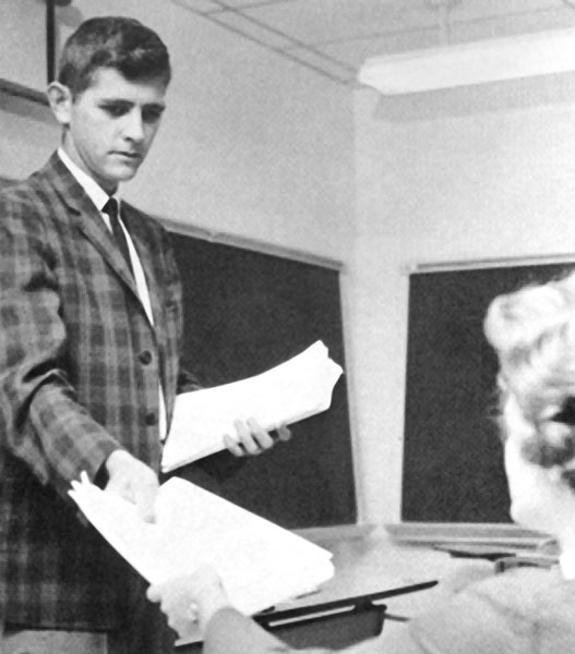 Dr. Lester Tuttle handing a woman papers