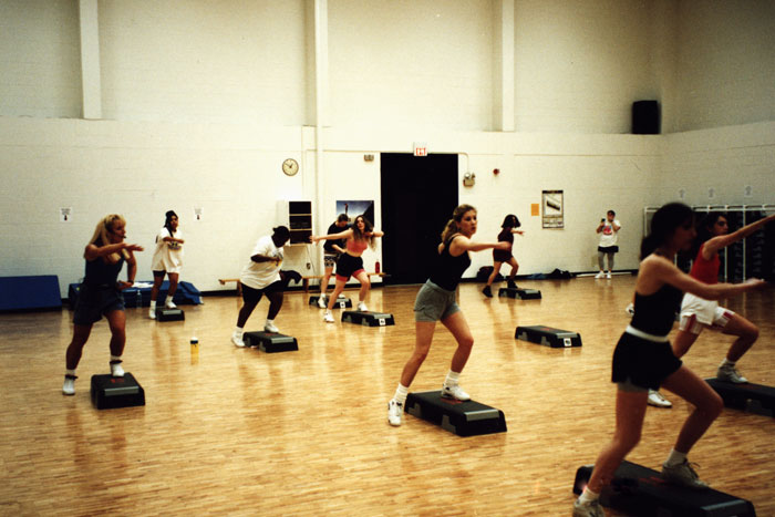 students engaging in step aerobics