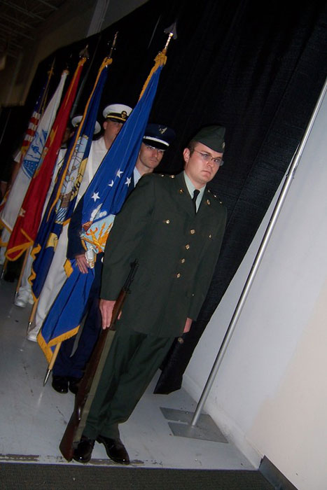 men in uniform holding flags