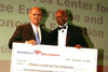 A thumbnail of two men holding a giant check