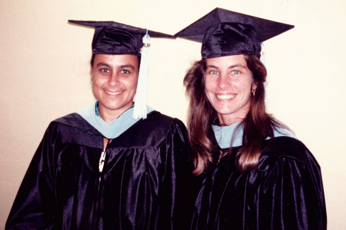 two students in gradutation gowns