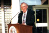 thumbnail of Dr. Gus A. Stavros standing at a podium