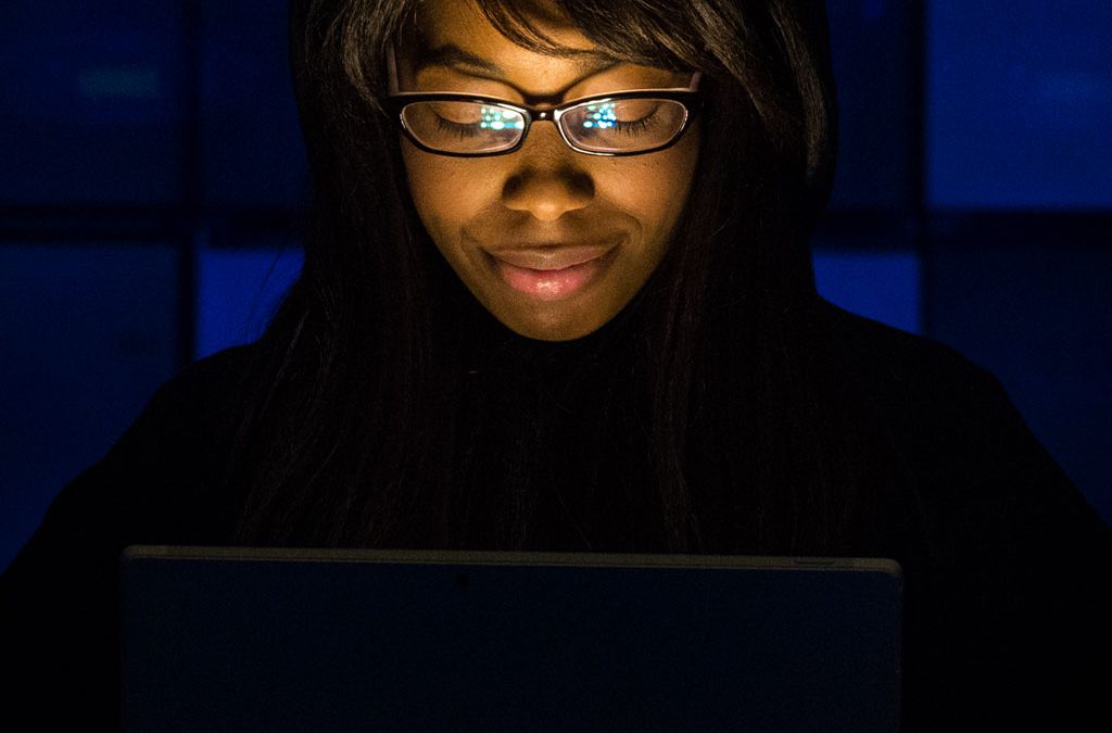 Woman’s Face Illuminated by Laptop