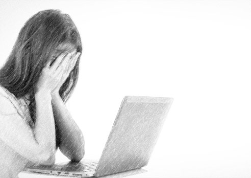 Girl Covering Face at Laptop