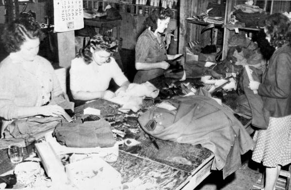 Women at Camp Gordon Johnston sewing on insignia